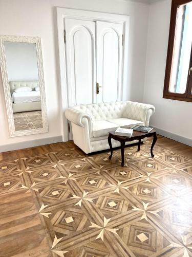 a living room with a couch and a table and a mirror at The B Collection - San Marco Riva schiavoni in Venice