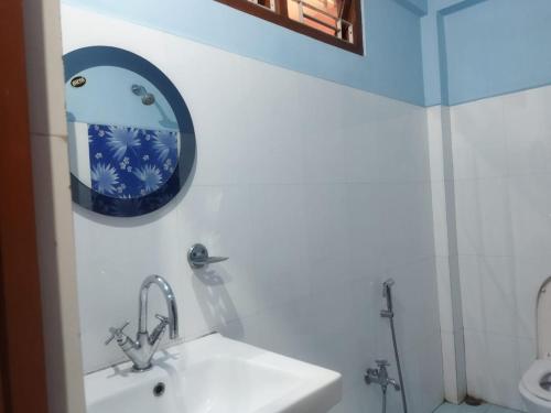 a bathroom with a sink and a mirror at Hotel Nambrog in Bomdila