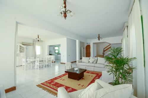 a living room with a couch and a table in it at Beach house First Row sea view at Santa Monica next to Almaza Bay in Marsa Matruh