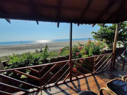 a view of the beach from the porch of a beach house at Bluemoon By Neelchand in Canacona