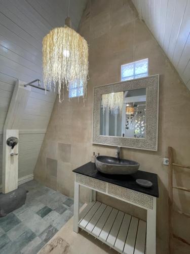 a bathroom with a sink and a mirror at Piramida's White Villa's Bali in Canggu