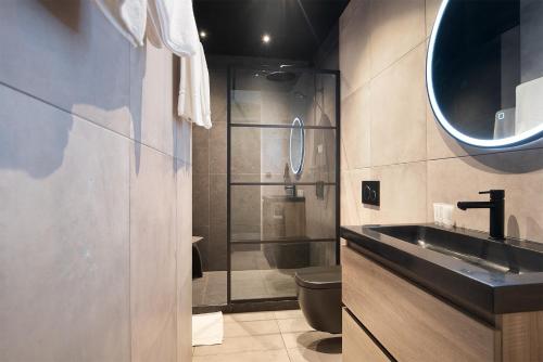 a bathroom with a sink and a shower at Modern Residence in Amsterdam