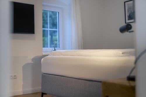 a bed in a room with a television on the wall at fil HOME in Leisach