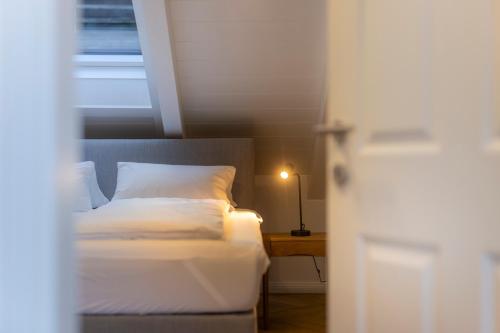 a bedroom with a bed and a table with a lamp at fil HOME in Leisach