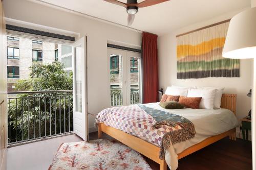 a bedroom with a bed and a balcony at Modern Residence in Amsterdam