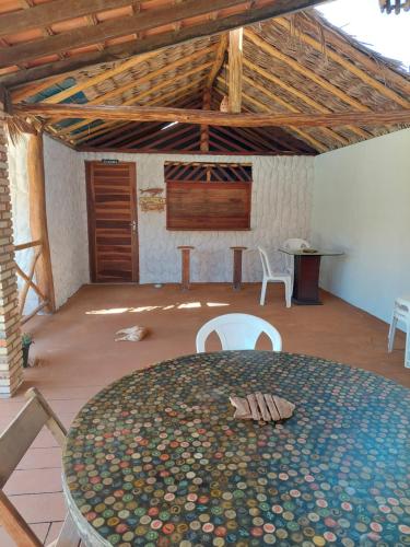 Großes Zimmer mit einem Tisch und Stühlen. in der Unterkunft Pousada Rio Leal in Luis Correia