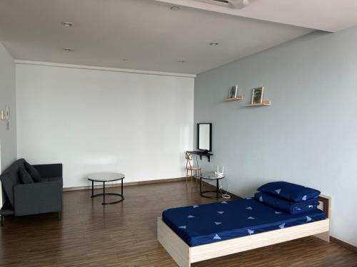 a room with a bed and a couch and a chair at Good Mood House 3-7pax,Free Parking,upstairs Shopping Mall, Hospital Columbia, TAR University, LRT Station in Kuala Lumpur