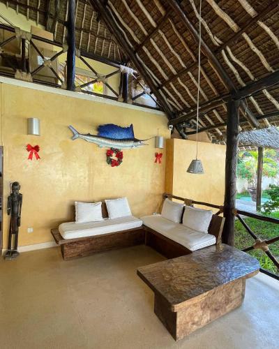 a living room with two couches and a table at Mawe Zuri Resort in Watamu