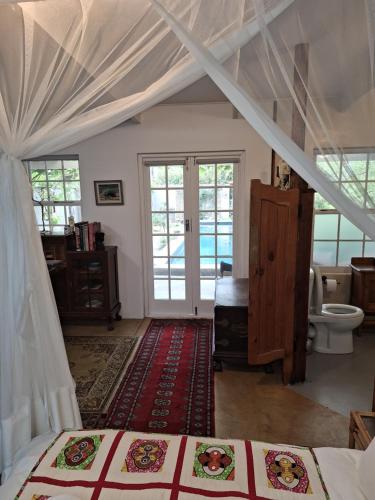 a bedroom with a bed and a bathroom at Rhus Cottage. in Stanford