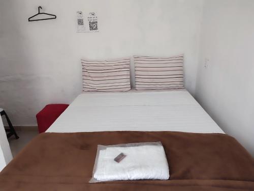 Ένα ή περισσότερα κρεβάτια σε δωμάτιο στο Minha casa pousada