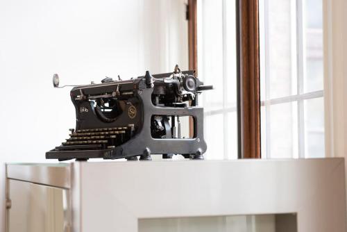 a black typewriter sitting on top of a refrigerator at The View - spacious 2 bdr appt in with view in Antwerp