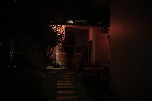 a dark room with a brick house at night at SkyLounge Residency in Trivandrum