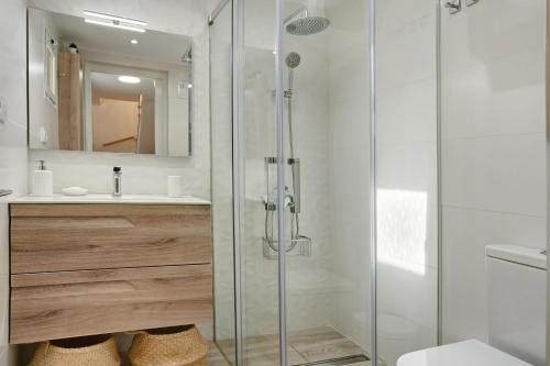 a bathroom with a glass shower and a sink at Bungalow Sonemar Sunshine in Maspalomas