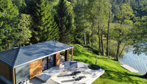 an overhead view of a house with a patio and water at Villa The Lake in Mindūnai