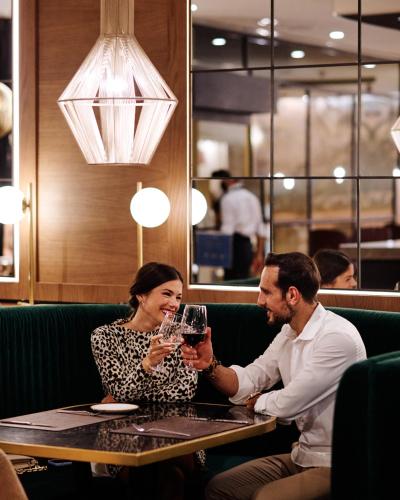 a man and woman sitting at a table drinking wine at Molina Lario in Málaga
