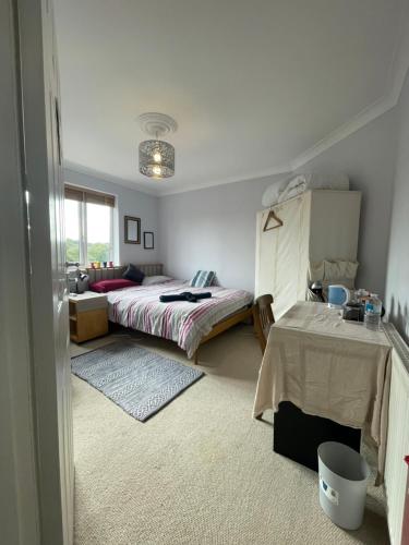 a bedroom with two beds and a table in it at Home from home Norwich centre in Norwich