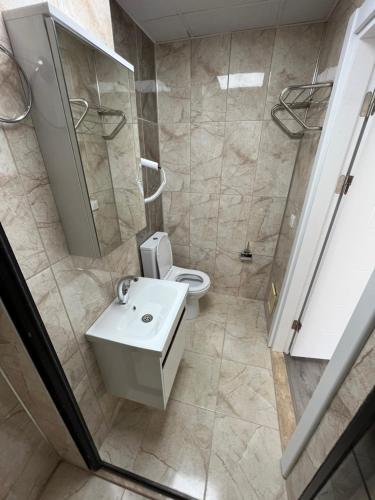 a bathroom with a toilet and a sink and a shower at Maritsa Comfort Plus in Edirne