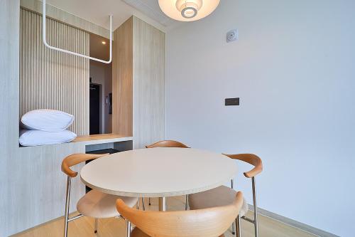 a white table and chairs in a room at Browndot Signature Hotel in Changwon