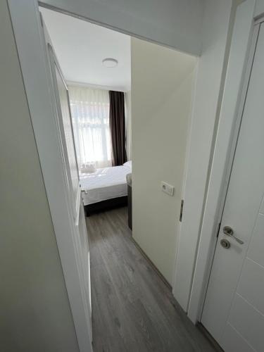 a room with a bedroom with a bed and a mirror at Maritsa Comfort Plus in Edirne