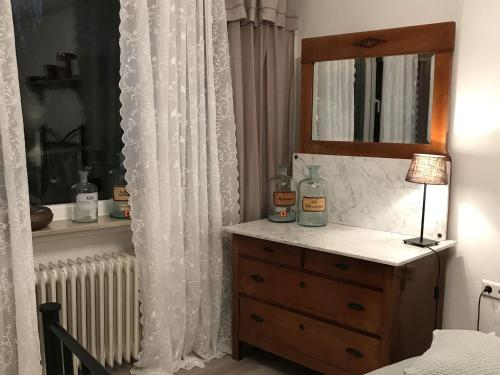 a bedroom with a dresser with a mirror and a radiator at Ferienhaus Schillerstraße in Münsingen