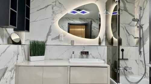 a white bathroom with a sink and a mirror at Sunhill Residence 5* suite Castle district in Budapest