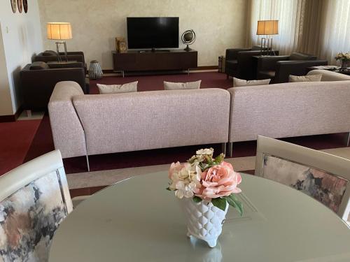 a vase of flowers on a table in a living room at Hotel SJ in Tondela