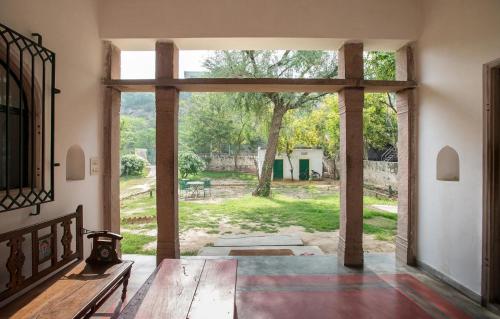 an open door to a patio with a view of a yard at Kawa Guest House in Jaipur