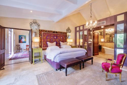 a large bedroom with a large bed and a bathroom at La Residence in Franschhoek