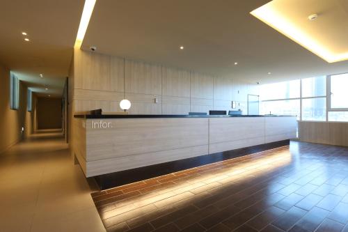 a lobby of an office building with a counter at Browndot Signature Hotel in Changwon