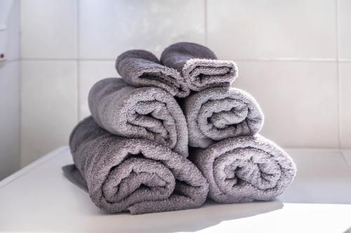 a pile of towels sitting on top of a toilet at Weingartnerhof Dalia in San Genesio Atesino