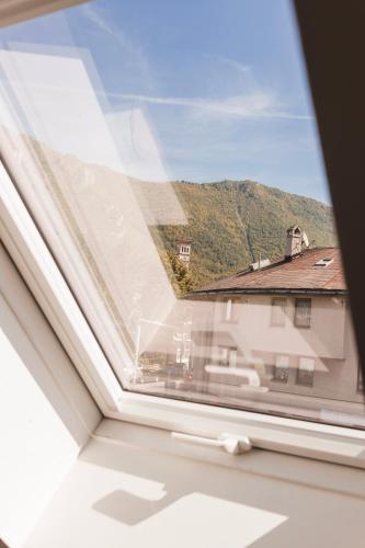 a window with a view of a house at Downtown Apartment Travnik in Travnik