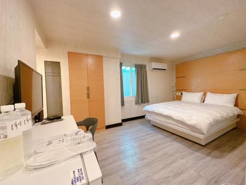 a hotel room with a bed and a desk at 新獅城商務旅店New Lion City Hotel in Taipei