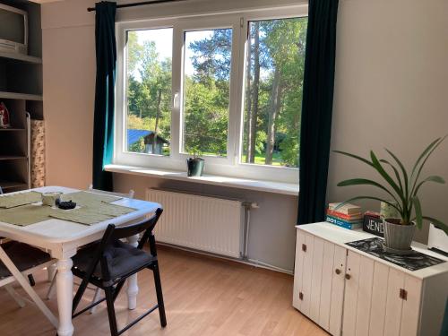 a dining room with a table and a window at Labākā vieta uz pasaules in Jūrmala