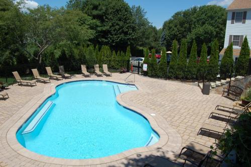 a swimming pool with lounge chairs at Sea Rose Suites in Ogunquit