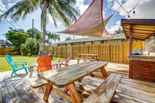 a wooden deck with a wooden table and chairs at LoKal Rental Tropical Florida destination in Fort Lauderdale
