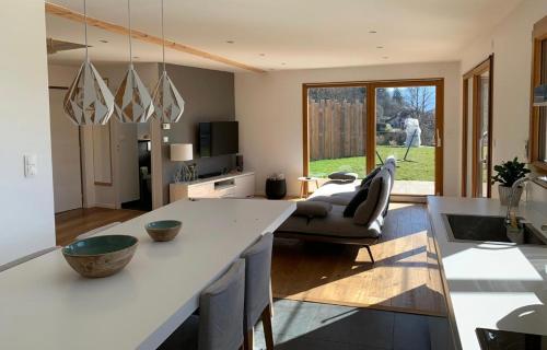 a kitchen and living room with a large white counter top at Belle maison avec jardin et vue montagne in Epagny Metz-Tessy