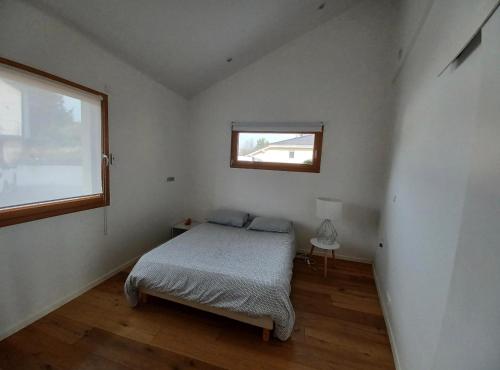 a small bedroom with a bed and a window at Belle maison avec jardin et vue montagne in Epagny Metz-Tessy