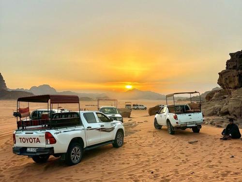a group of vehicles parked in the desert at Wadi Rum Aviva camp in Wadi Rum