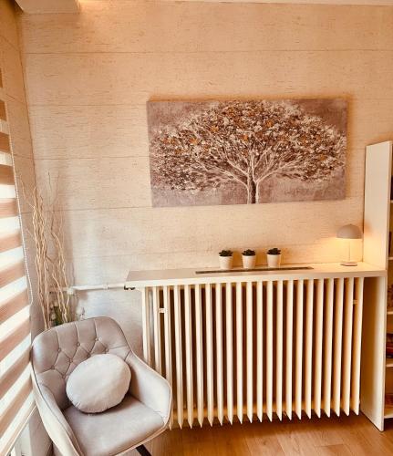 a living room with a radiator and a chair at Vanja in Čukarica