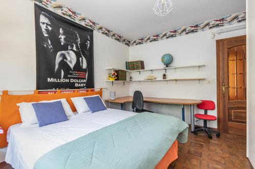 a bedroom with a large bed and a desk at Asti Lovely Apt - Private Parking & Balconies in Asti