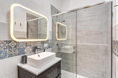 a bathroom with a sink and a shower at Vesuvio Home Capodichino in Naples