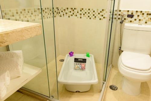 a bathroom with a toilet and a shower at Comfort Suites Alphaville in Barueri