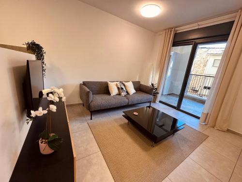 a living room with a couch and a coffee table at Lincoln Design Apartments in Jerusalem