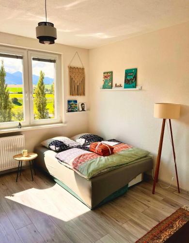 a bedroom with a bed in a room with a window at Little View in Liptovský Mikuláš