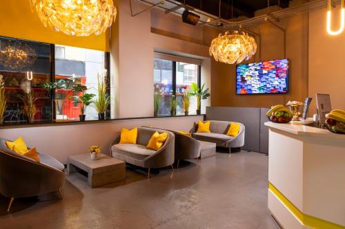 a waiting room with couches and a tv at REZz Dublin in Dublin