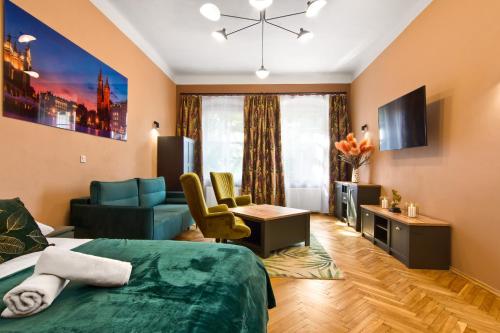 a hotel room with a bed and a living room at Mikołajska 5 Apartments in Krakow