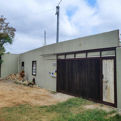 a building with a large wooden garage door at Villa a arte de Minas in Tiradentes