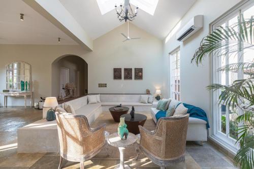 a living room with a couch and chairs at LohonoStays Colina Villa E in Vagator