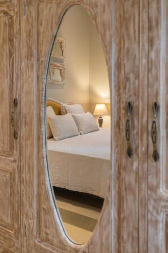 a bedroom with a bed and a mirror at LohonoStays Colina Villa E in Vagator