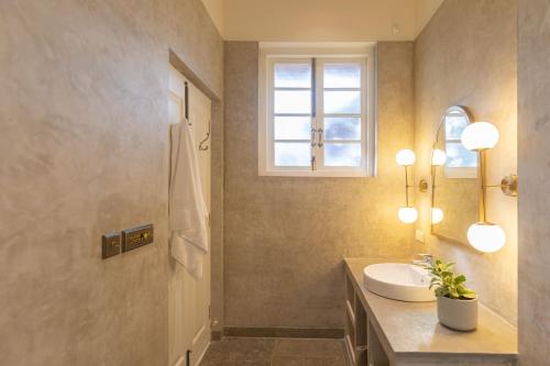 a bathroom with a sink and a window at LohonoStays Colina Villa E in Vagator